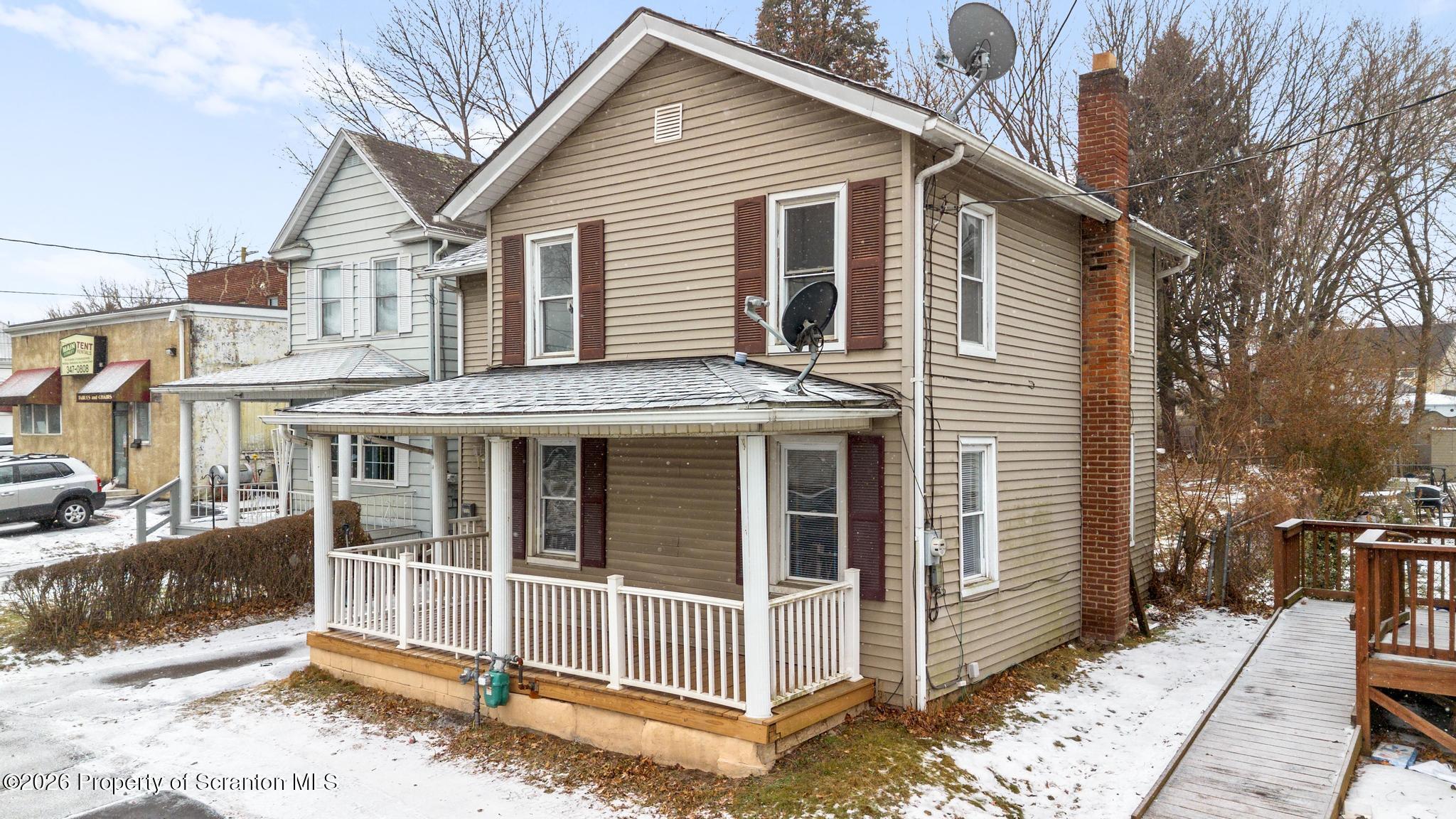 2717 North Main Avenue Scranton, PA 18508 - Photo 4 of 36 a view of a white house with large windows