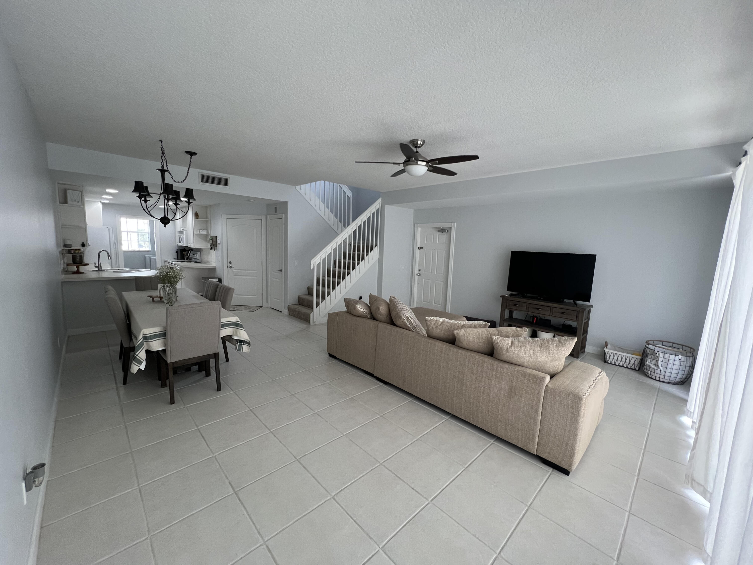482 Capistrano Drive Palm Beach Gardens, FL 33410 - Photo 4 of 9 a living room with furniture and a flat screen tv