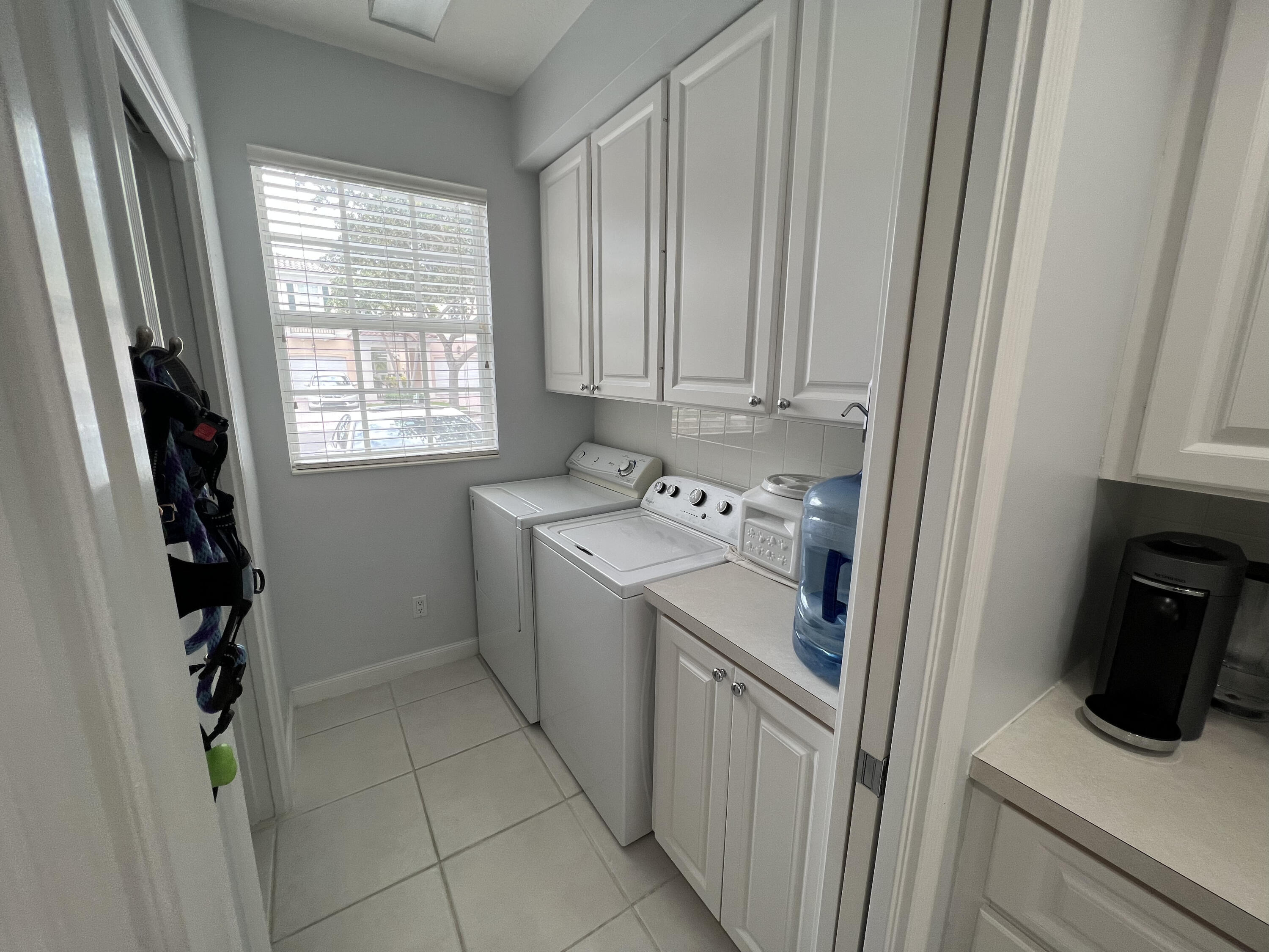 482 Capistrano Drive Palm Beach Gardens, FL 33410 - Photo 6 of 9 a utility room with dryer and washer