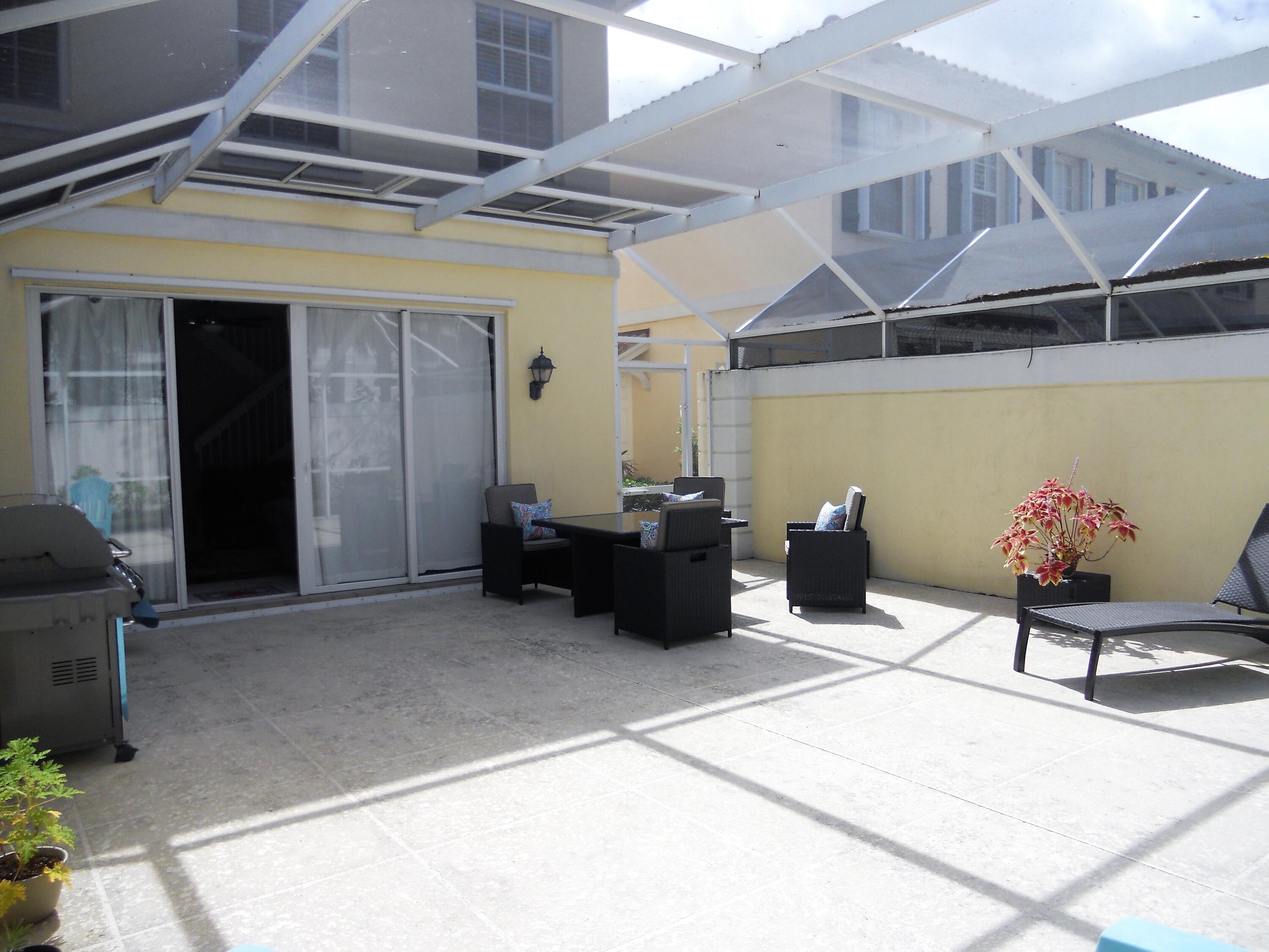 482 Capistrano Drive Palm Beach Gardens, FL 33410 - Photo 8 of 9 a view of a patio with table and chairs