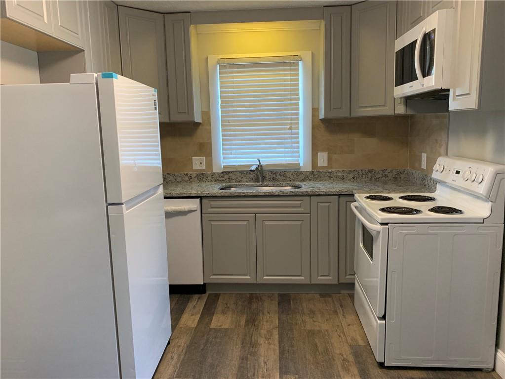 1261 Concord Road Southeast Smyrna, GA 30080 - Photo 18 of 50 a kitchen with a sink a stove and a refrigerator