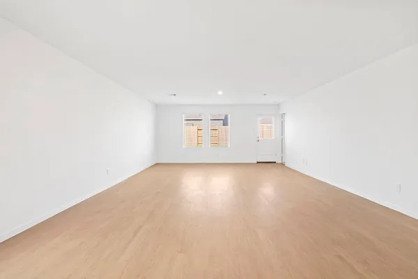 a view of a pool with lawn chairs and a dining table