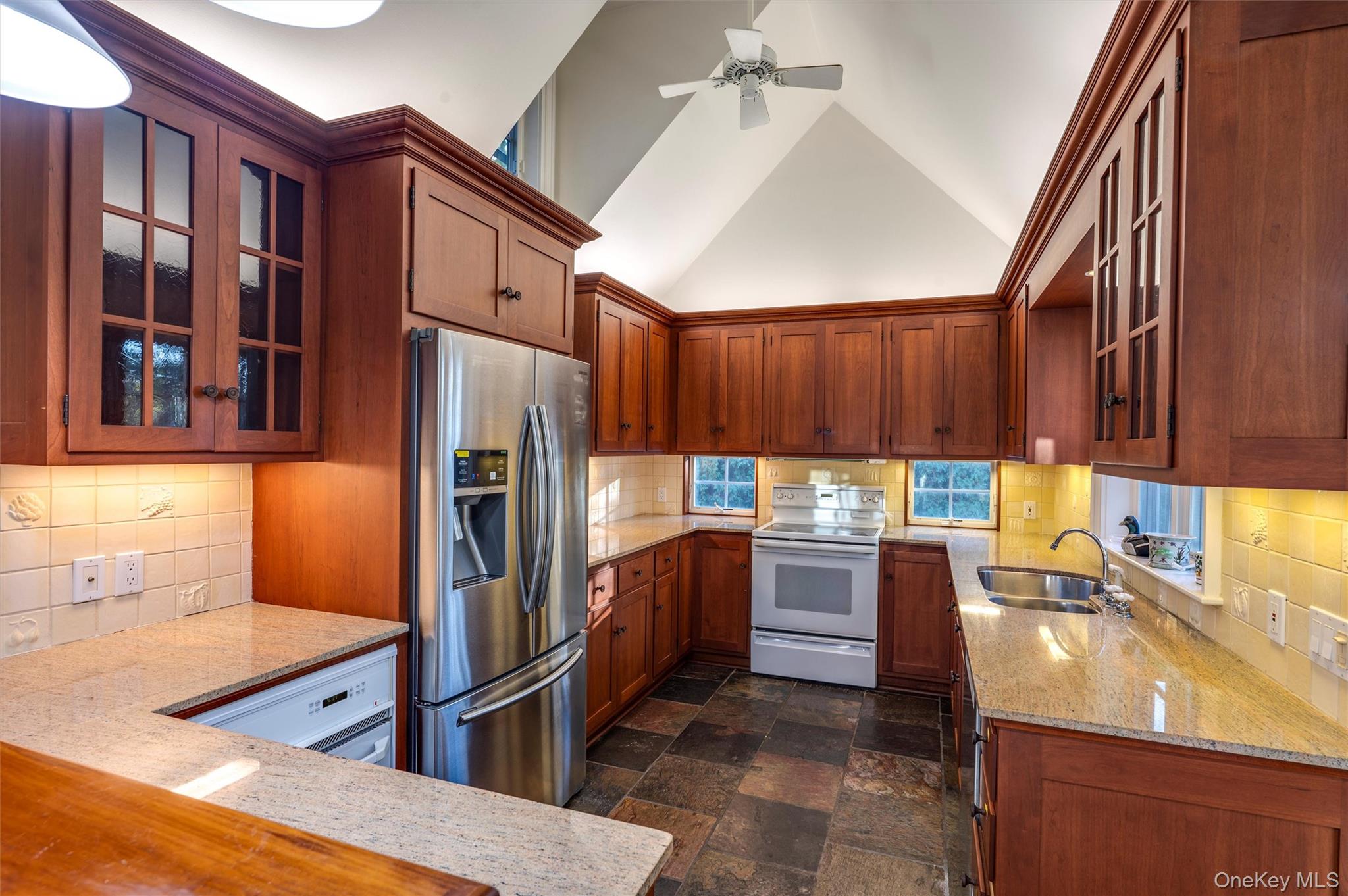 8 Fish Creek Lane Remsenburg, NY 11960 - Photo 16 of 34 a kitchen with a refrigerator sink and stove