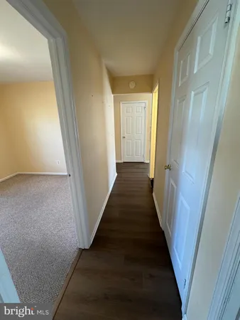 a view of a hallway with a wooden floor