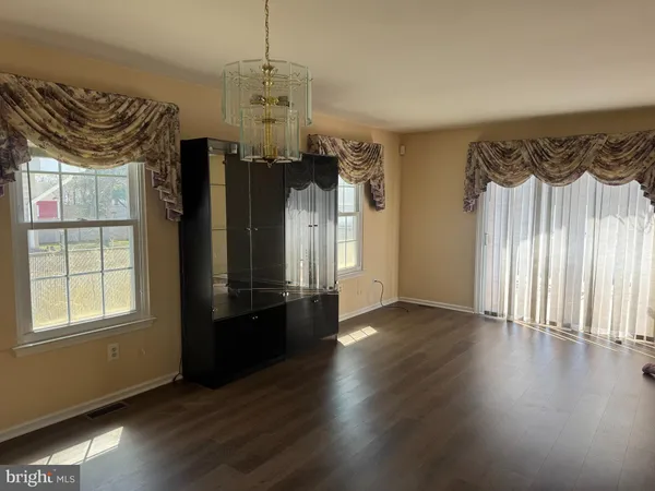 a view of a livingroom with wooden floor and a window