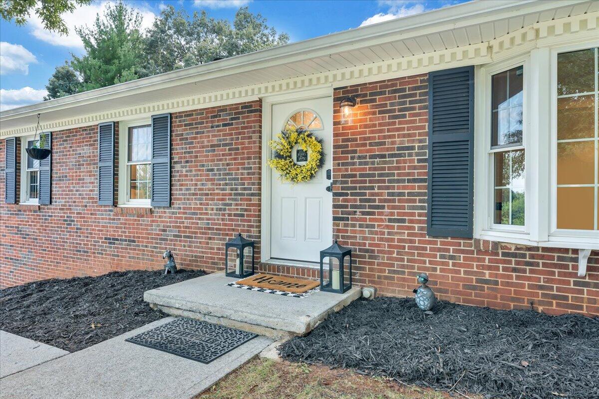 240 Lakeshore Terrace Road Hardy, VA 24101 - Photo 2 of 102 a view of a brick house with a backyard