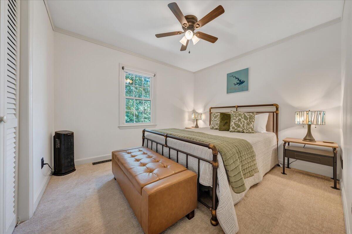 240 Lakeshore Terrace Road Hardy, VA 24101 - Photo 31 of 102 a bedroom with a bed and a chandelier