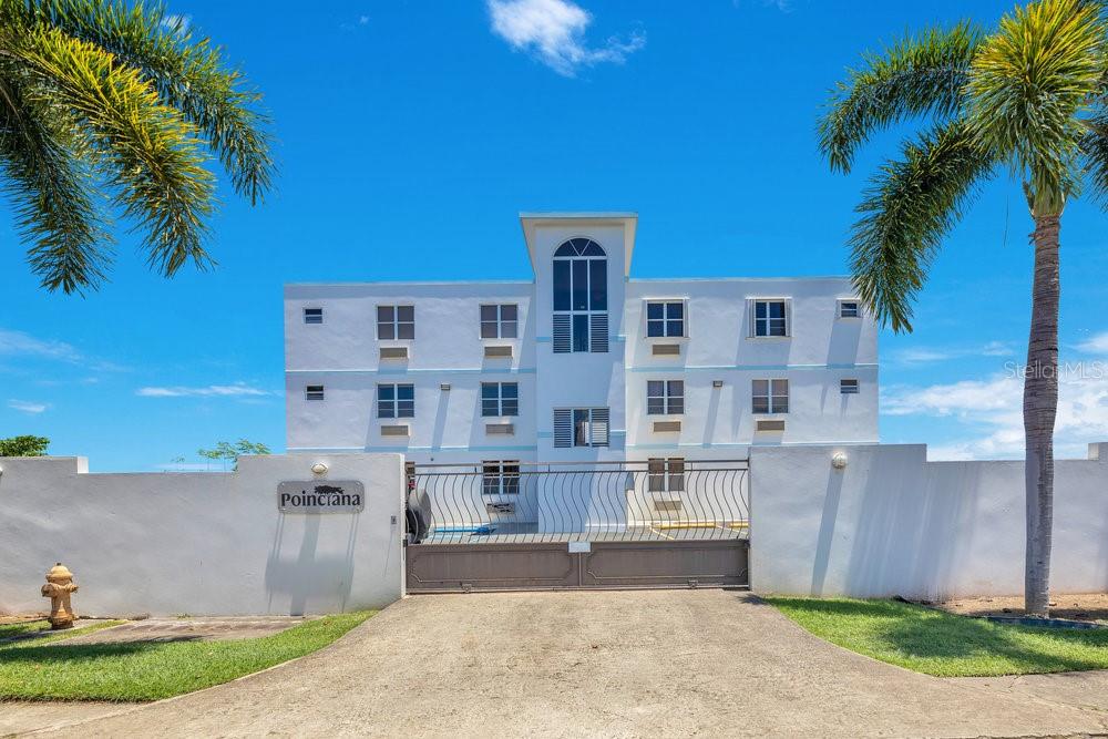 413 Camino Carretas, Unit A7 Rincon, Rincón 00677 - Photo 3 of 23 a front view of a house with a yard