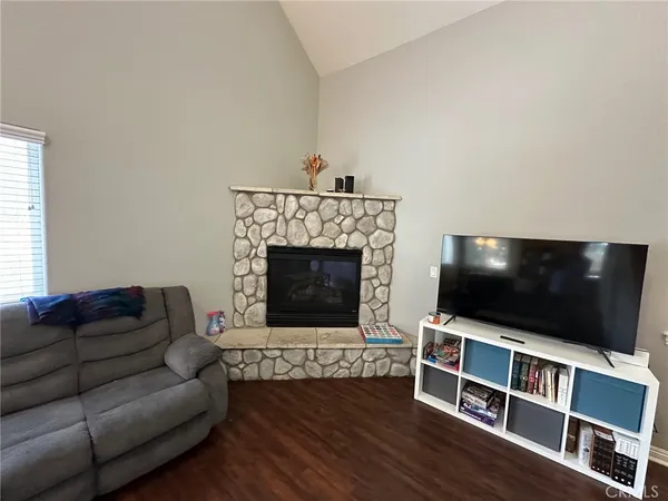 a view of a hallway to a livingroom with furniture