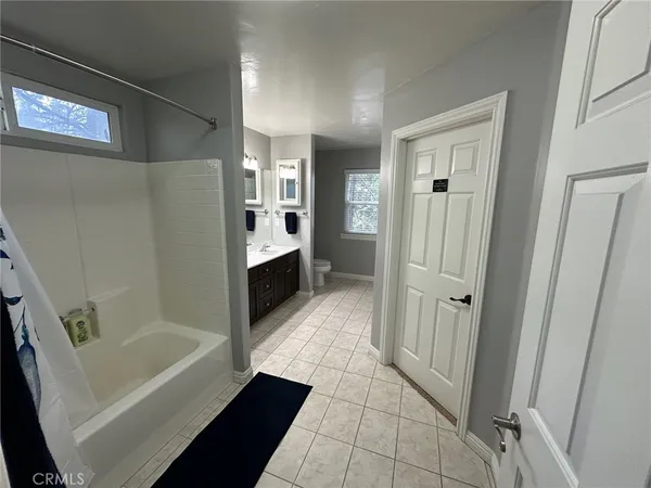 a bathroom with a sink double vanity and a mirror