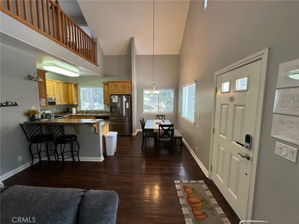 a kitchen with stainless steel appliances kitchen island granite countertop wooden floors and a white counter