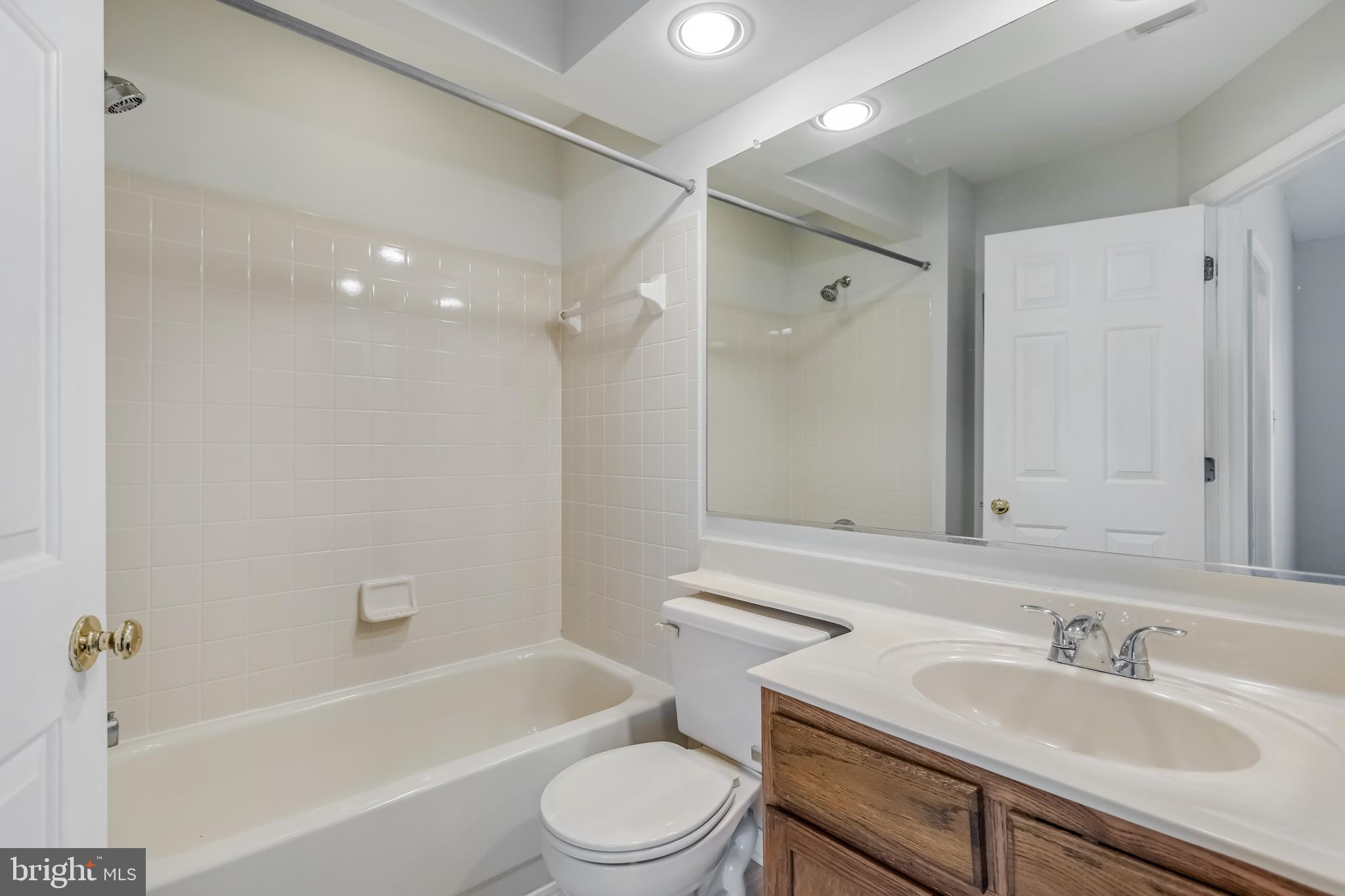 45550 Whitcomb Square Sterling, VA 20166 - Photo 11 of 24 a bathroom with a sink toilet vanity and shower