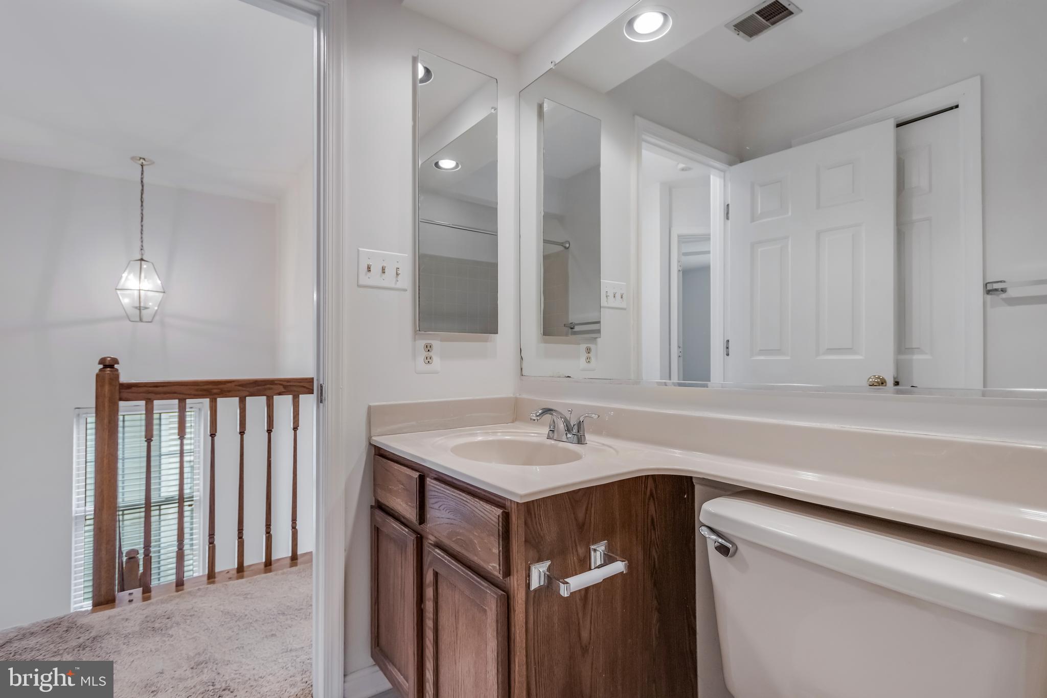 45550 Whitcomb Square Sterling, VA 20166 - Photo 16 of 24 a bathroom with a sink and a mirror