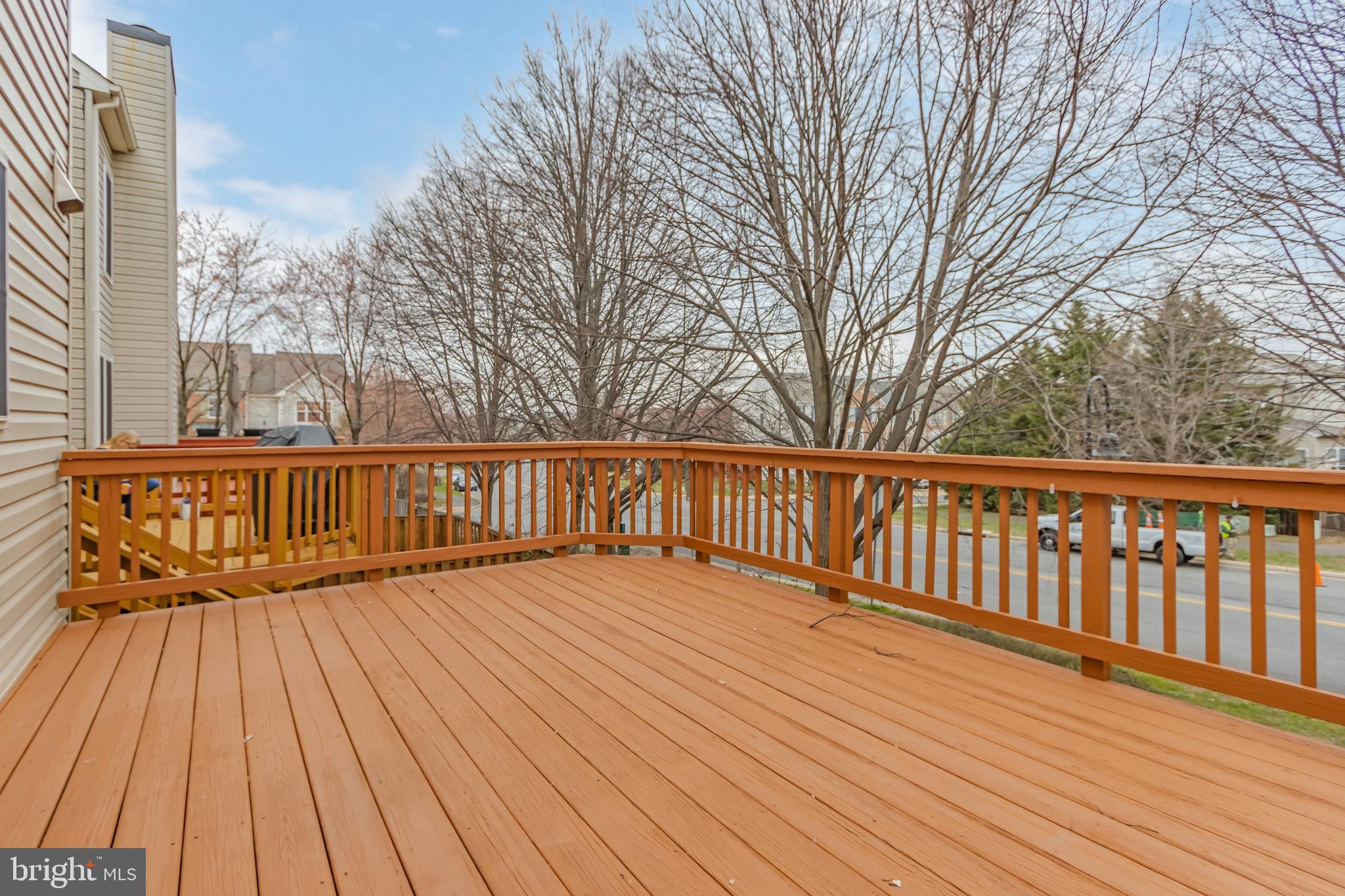 45550 Whitcomb Square Sterling, VA 20166 - Photo 20 of 24 a balcony with wooden floor and trees