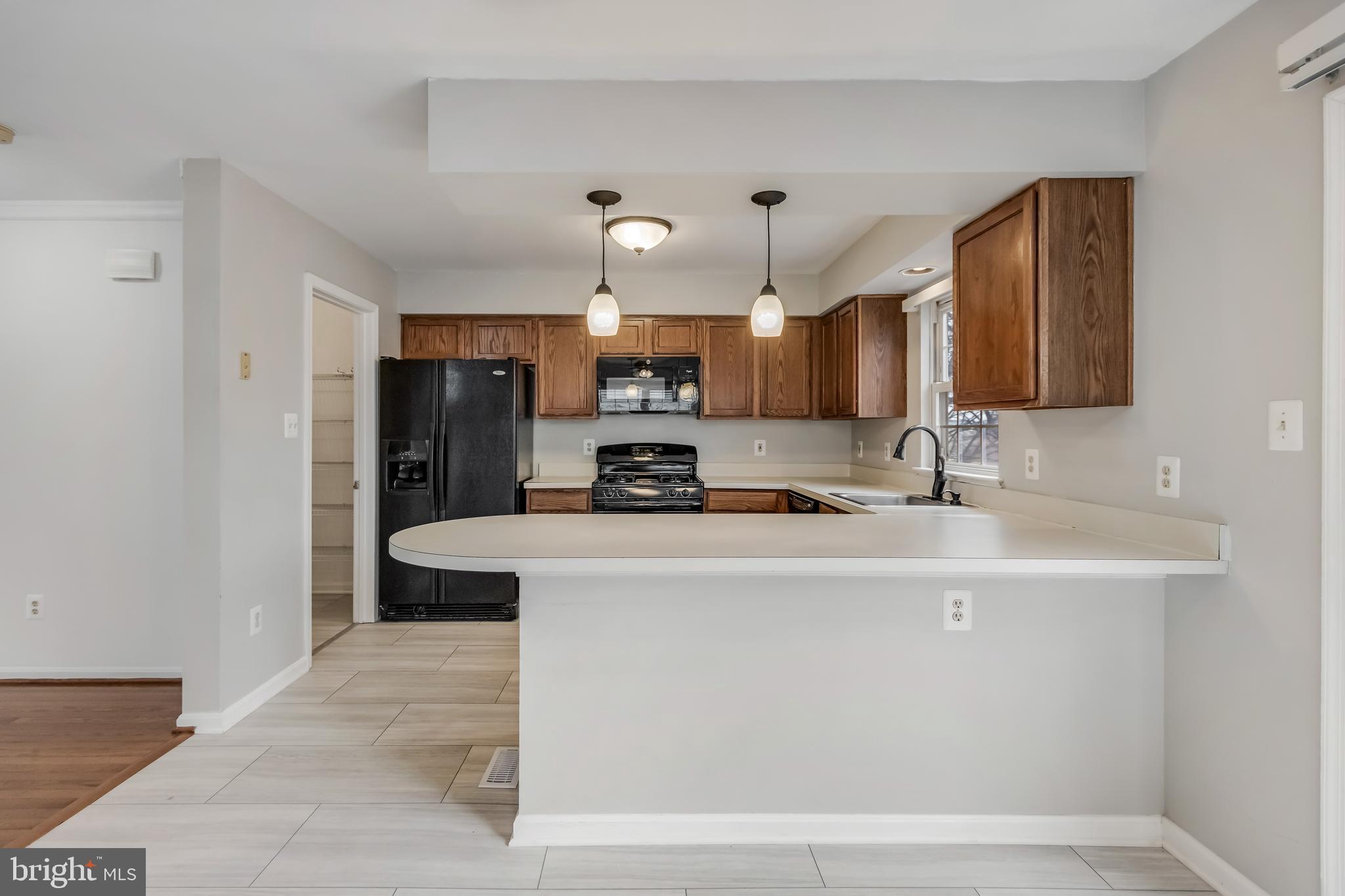 45550 Whitcomb Square Sterling, VA 20166 - Photo 3 of 24 a kitchen with kitchen island a sink stainless steel appliances and cabinets