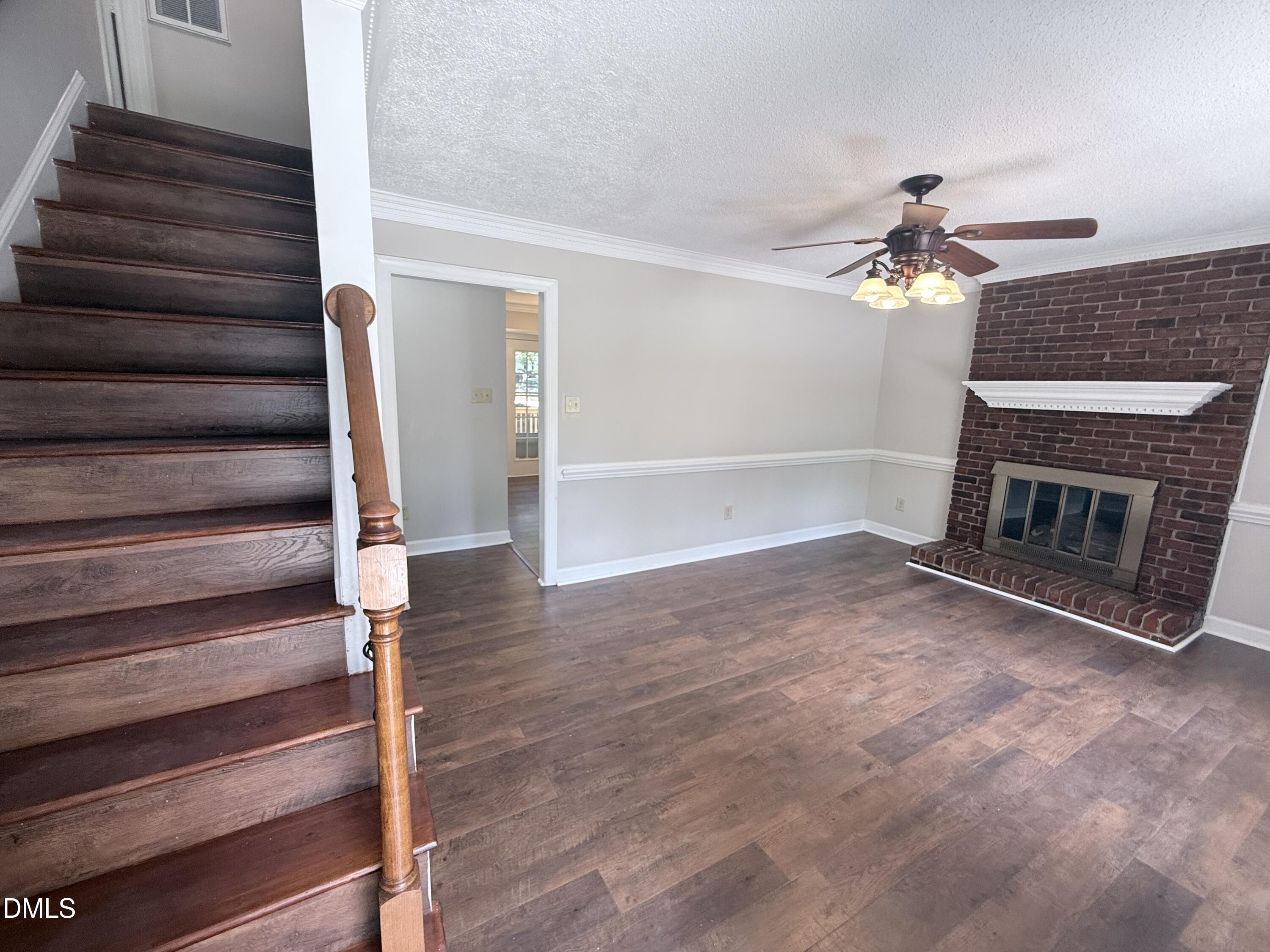 2900 Broadlands Drive Raleigh, NC 27604 - Photo 22 of 60 a view of an empty room with wooden floor fireplace and a window