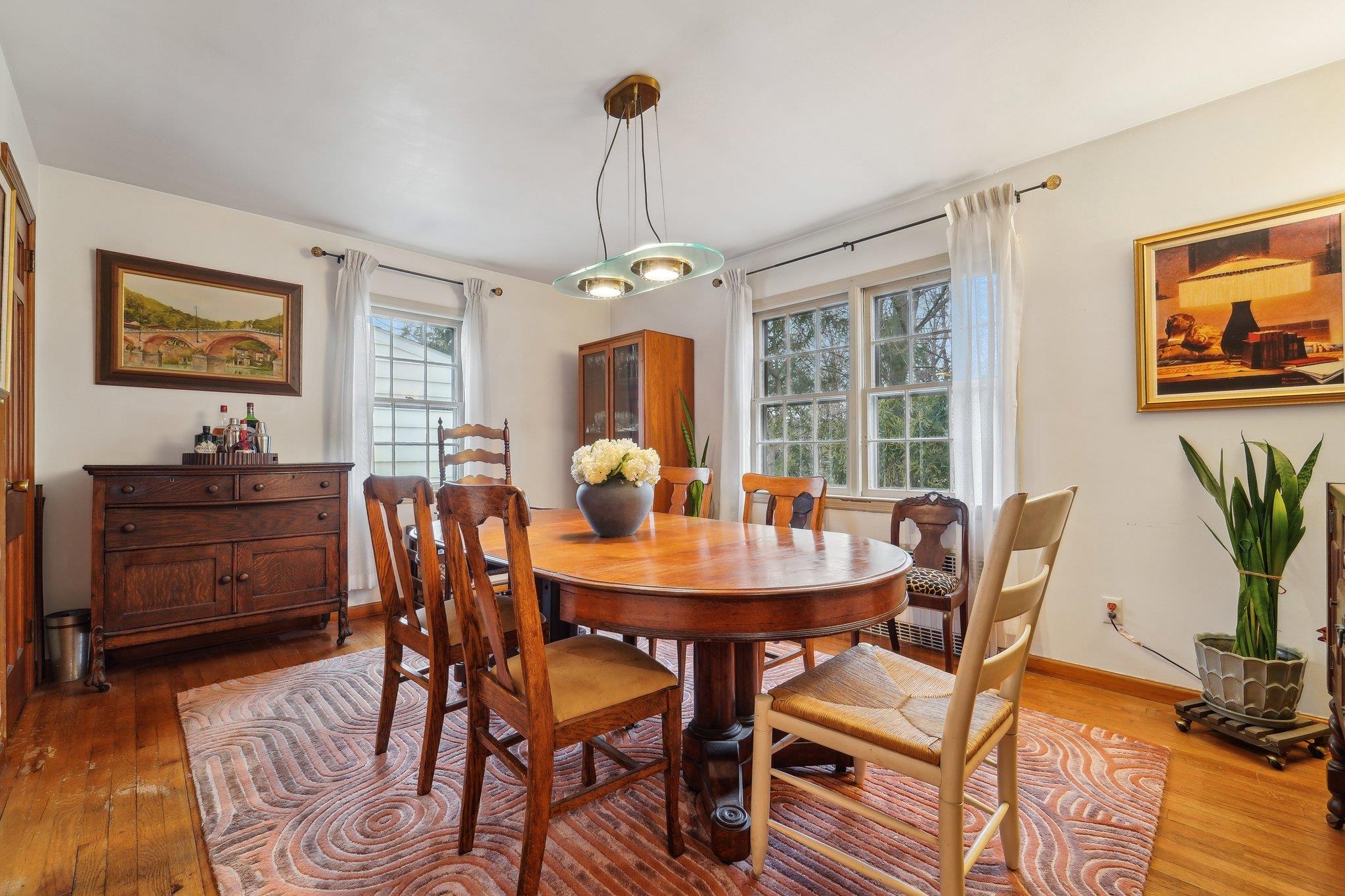 10 Wayside Drive White Plains, NY 10607 - Photo 1 of 1 a dining room with furniture a chandelier and wooden floor