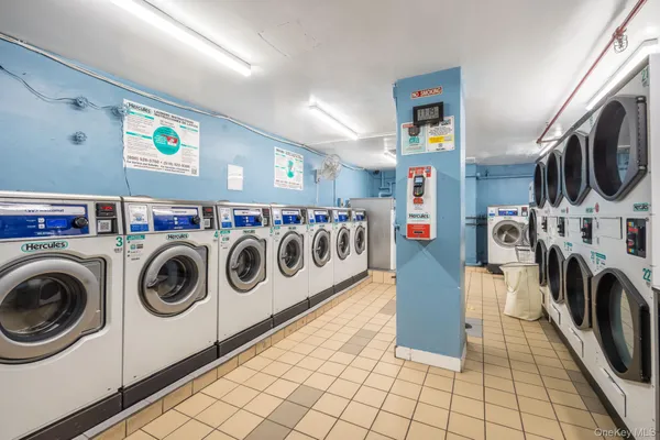 a utility room with fridge dryer and washer