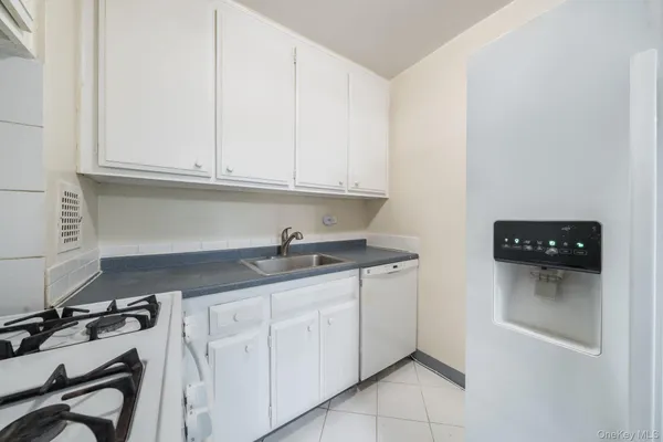 a kitchen with granite countertop a sink and cabinets