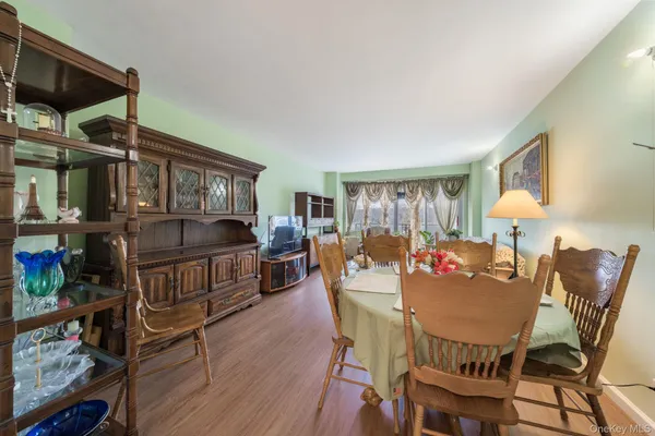 a dining room with furniture and wooden floor