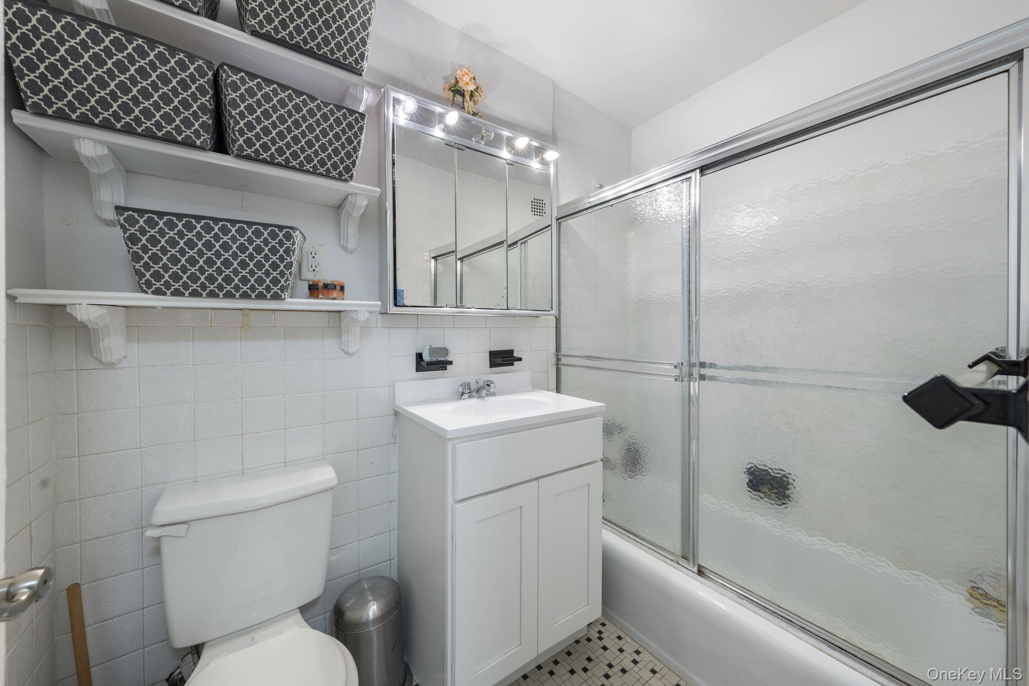 85-15 Main Street, Unit 3E Queens, NY 11435 - Photo 10 of 16 a bathroom with a sink toilet and shower
