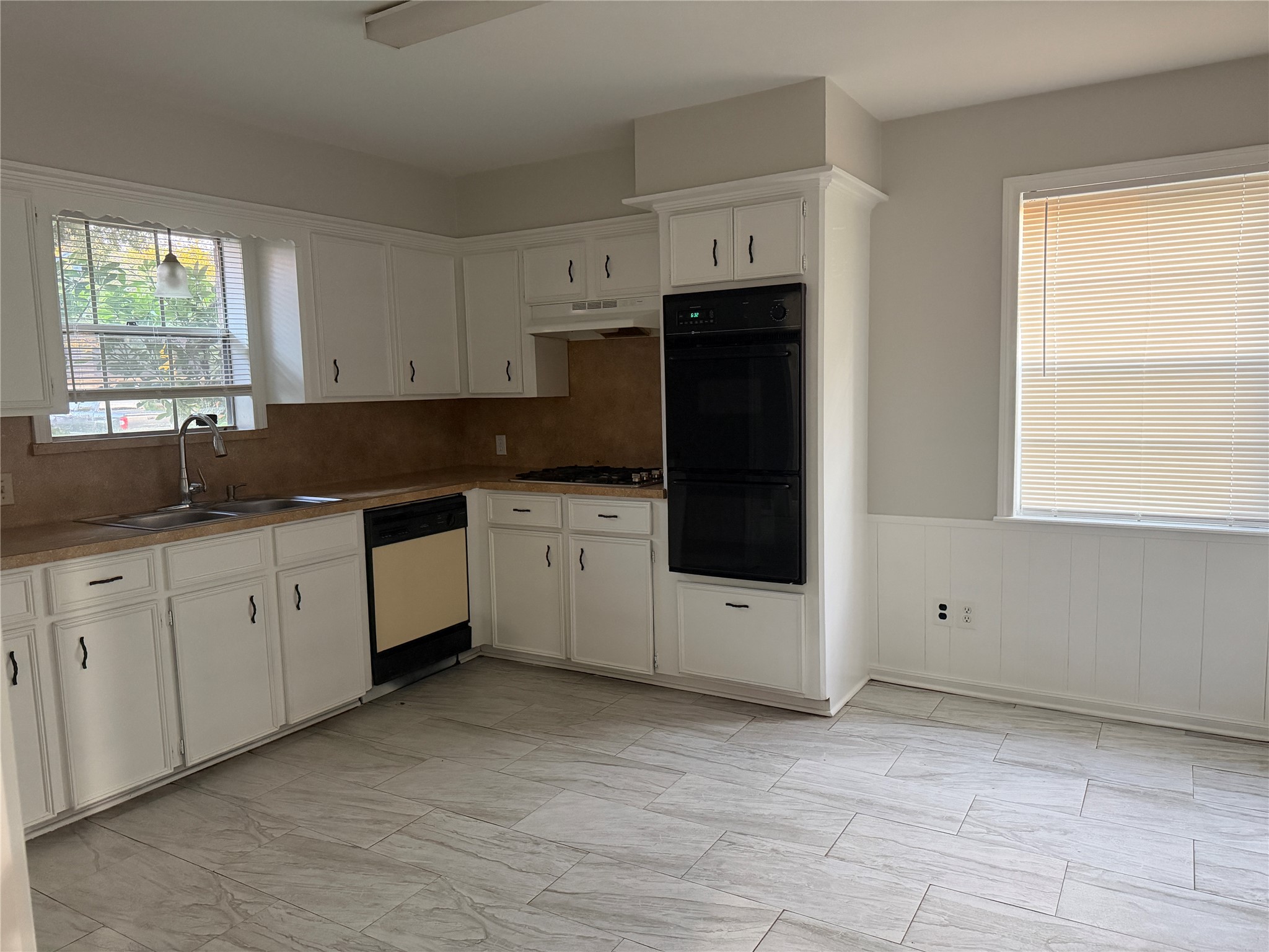 3815 Avenue R Rosenberg, TX 77471 - Photo 9 of 14 a kitchen with granite countertop white cabinets white stainless steel appliances and a sink