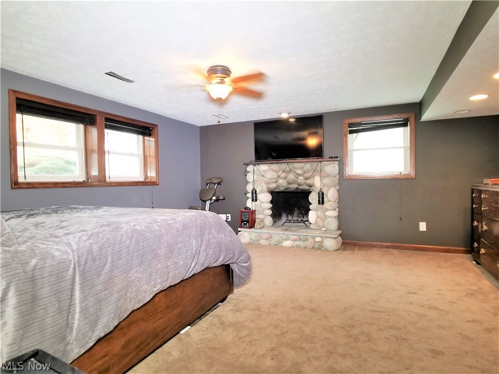 1560 Reed Street Canal Fulton, OH 44614 - Photo 1 of 7 Master bedroom suite with beautiful stone gas or woodburning fireplace. This space could also be used as an additional family room.