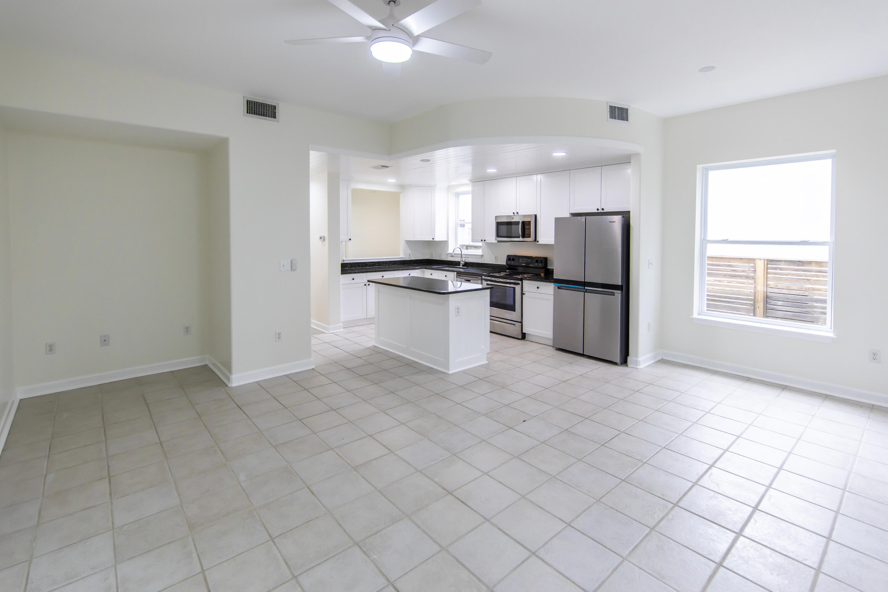 51 Loon Lake Drive Santa Rosa Beach, FL 32459 - Photo 14 of 49 a kitchen with stainless steel appliances kitchen island granite countertop a refrigerator and a stove top oven