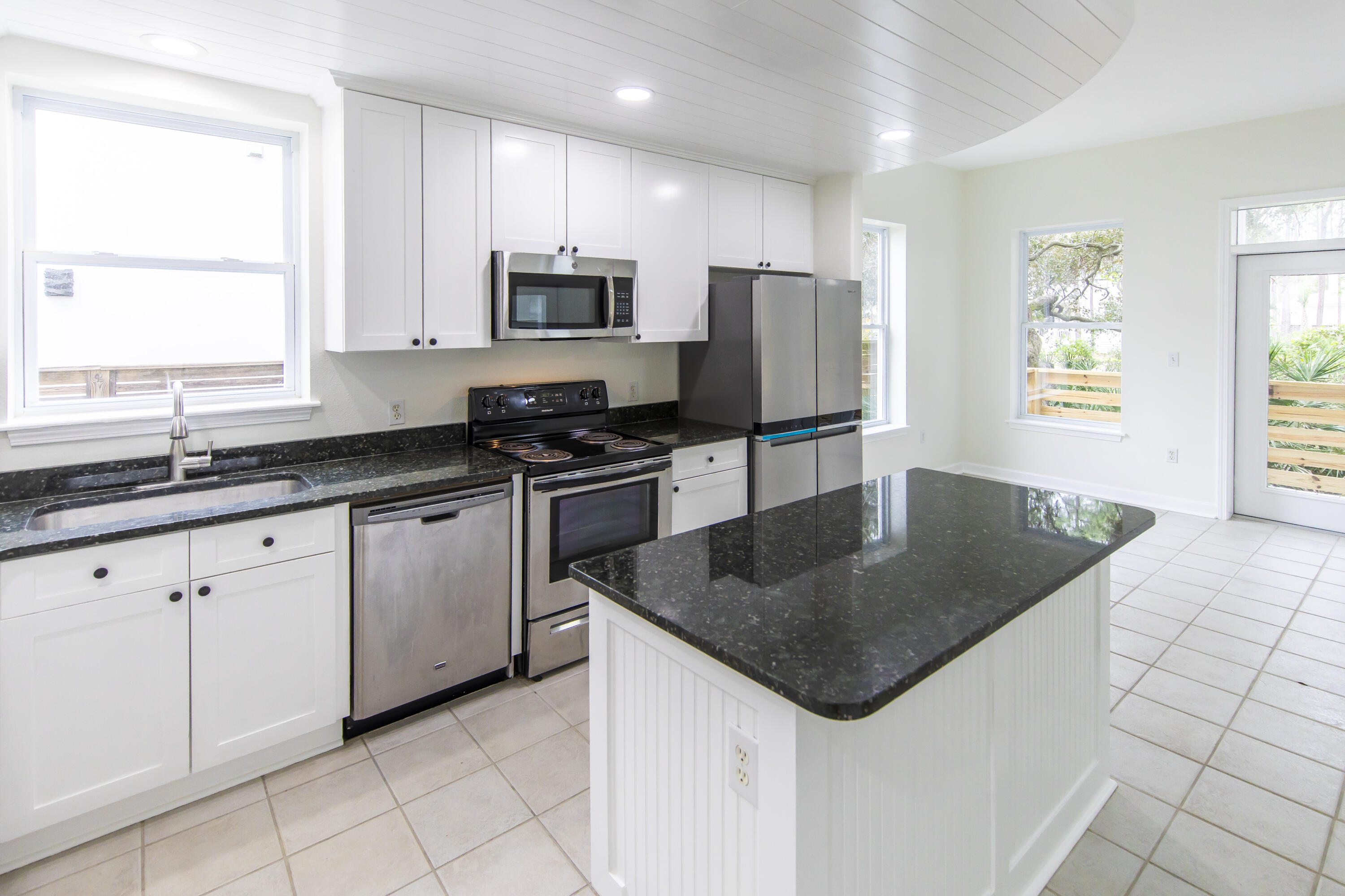 51 Loon Lake Drive Santa Rosa Beach, FL 32459 - Photo 16 of 49 a kitchen with granite countertop a sink stainless steel appliances a window and a counter top space