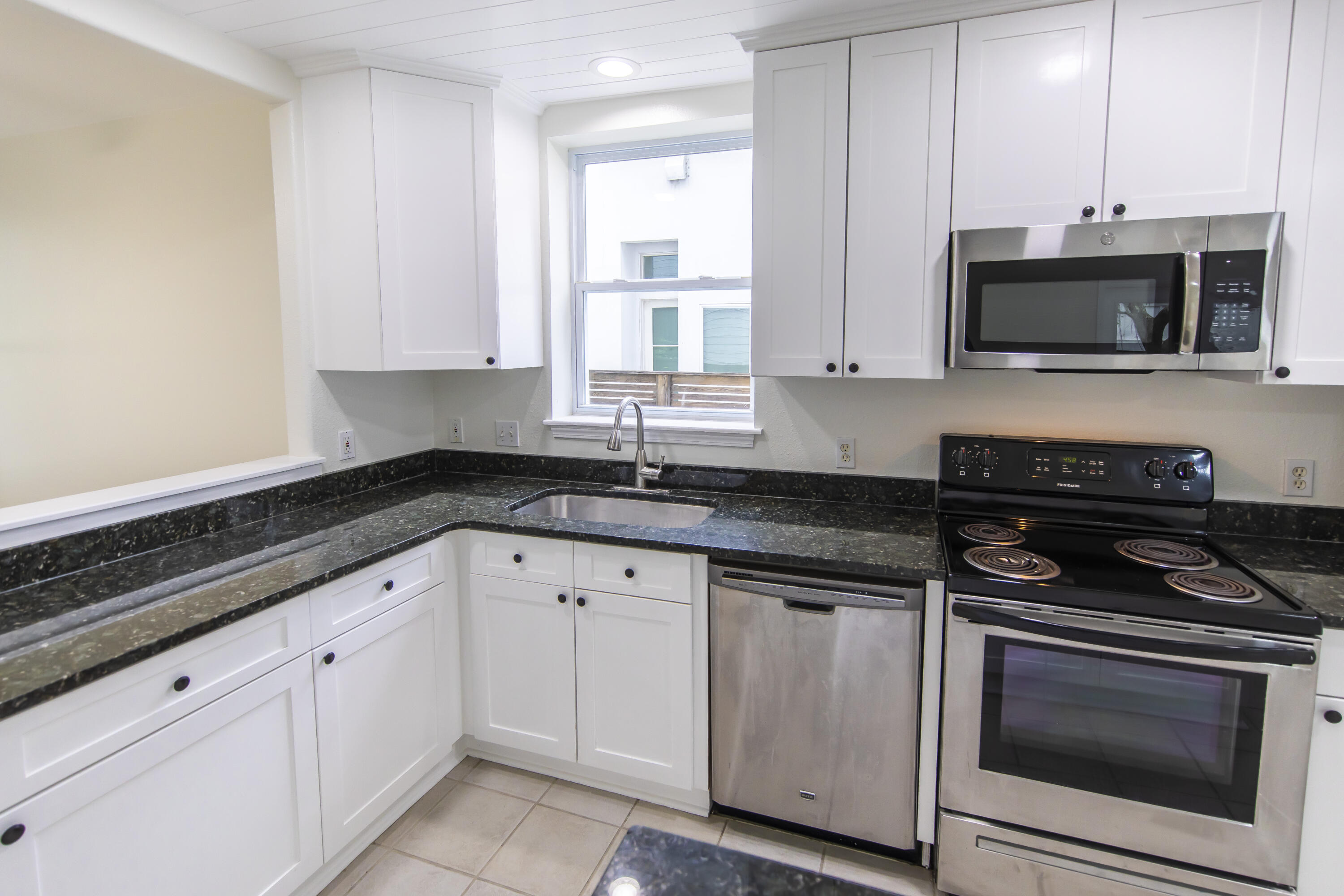 51 Loon Lake Drive Santa Rosa Beach, FL 32459 - Photo 17 of 49 a kitchen with granite countertop white cabinets stainless steel appliances and a sink