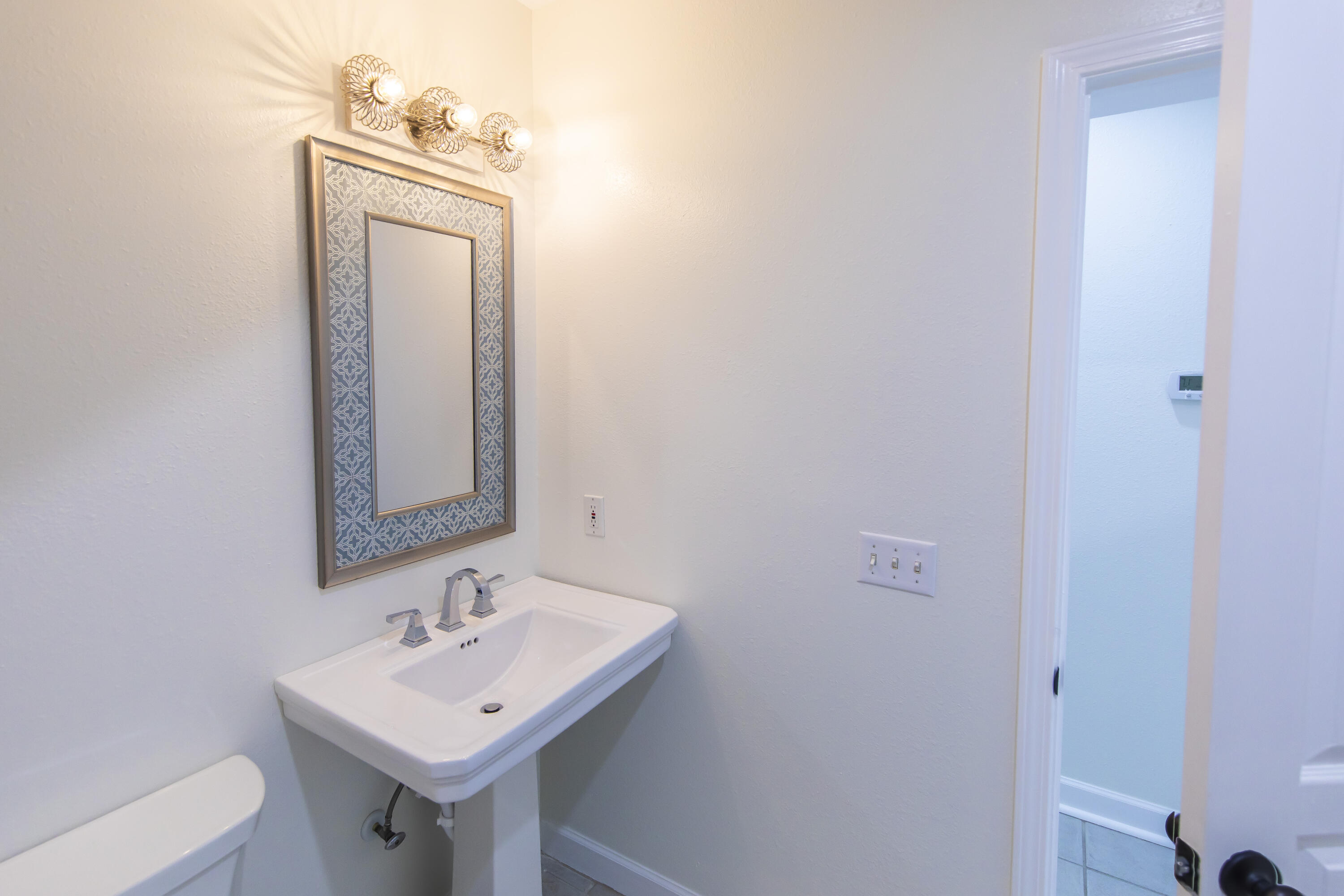 51 Loon Lake Drive Santa Rosa Beach, FL 32459 - Photo 18 of 49 a bathroom with a toilet sink and mirror