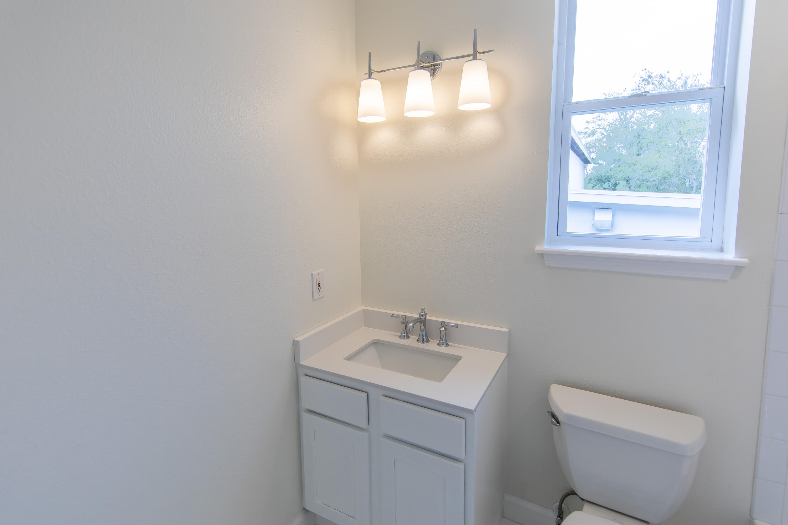 51 Loon Lake Drive Santa Rosa Beach, FL 32459 - Photo 32 of 49 a bathroom with a toilet sink vanity and mirror