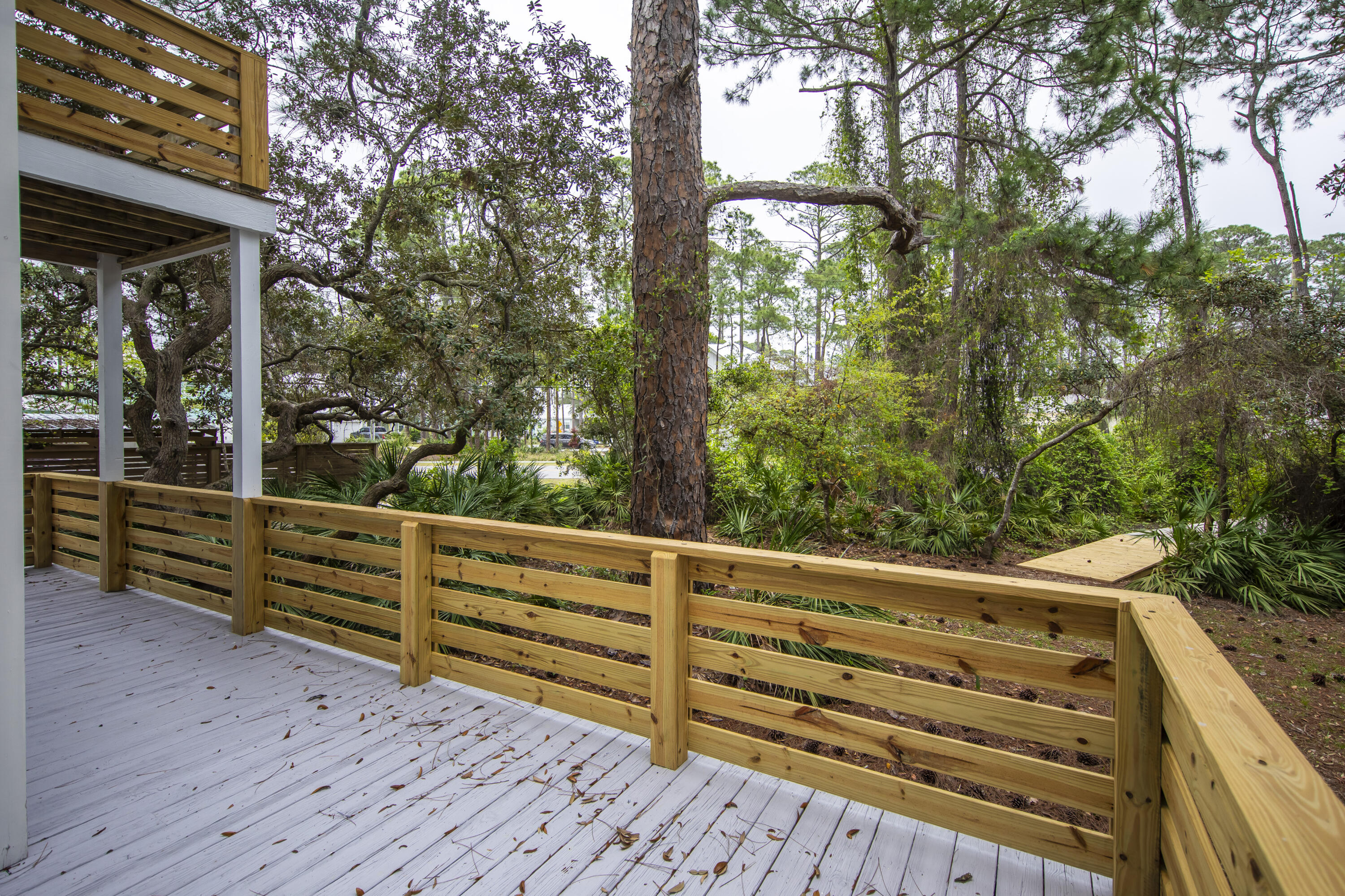 51 Loon Lake Drive Santa Rosa Beach, FL 32459 - Photo 8 of 49 a view of a wooden bench next to a yard