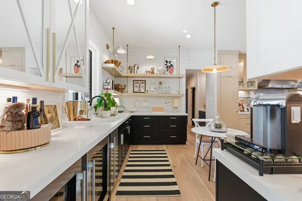 a living room with furniture dining table and a large window