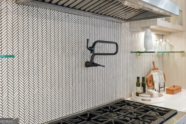 a kitchen with stainless steel appliances granite countertop a sink and a large window