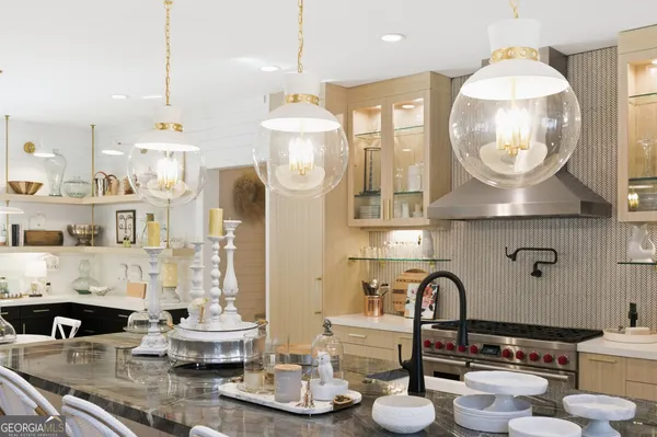 a living room with furniture a flat screen tv and a table