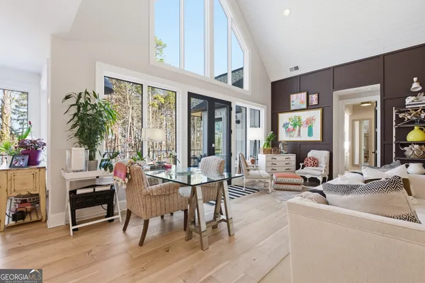 a bathroom with a toilet a sink a glass door a shower a mirror and vanity