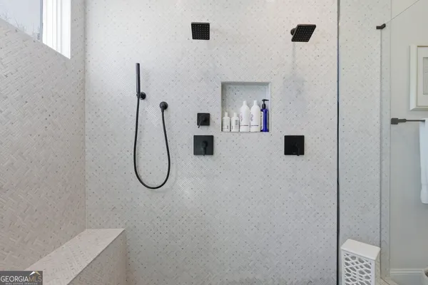 a living room with furniture kitchen and a chandelier