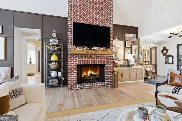 a kitchen with stainless steel appliances kitchen island granite countertop a stove a kitchen island a dining table and chairs with wooden floor