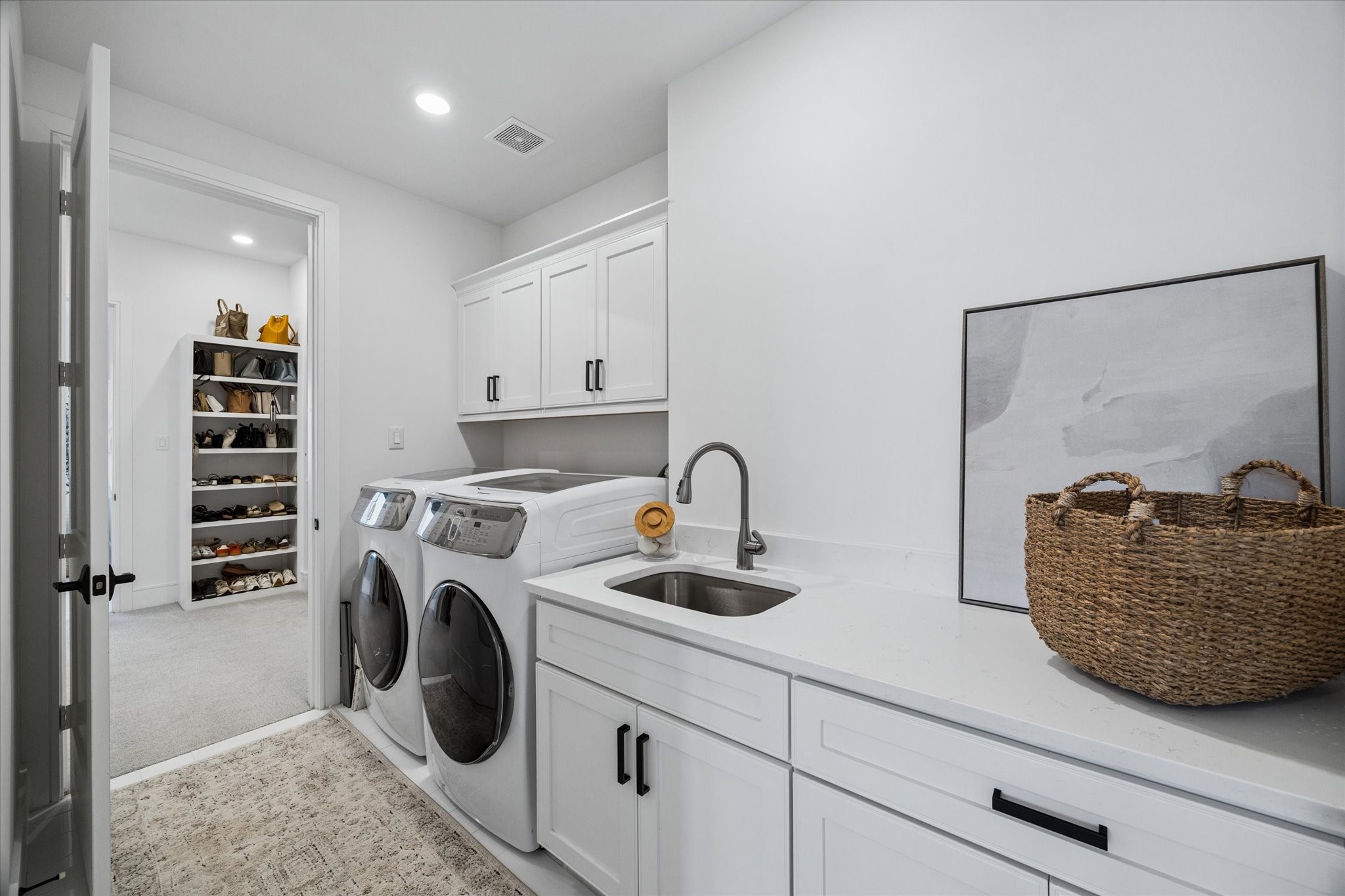 1661 Bingle Road Houston, TX 77055 - Photo 22 of 33 laundrette closet with side by side washer & dryer, cabinetry & separate sink. tile floors. appliances convey with the home.