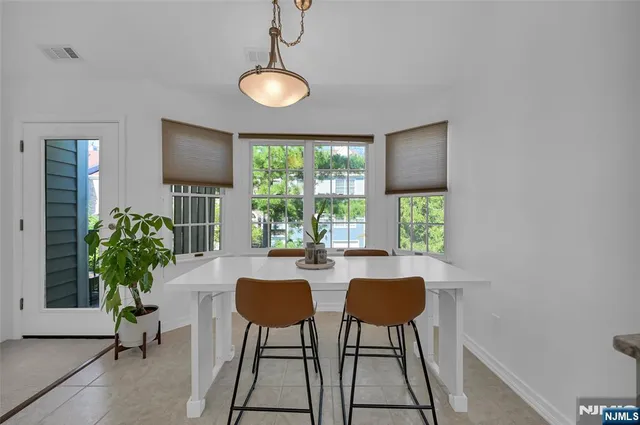 a view of a livingroom with furniture and a potted plant