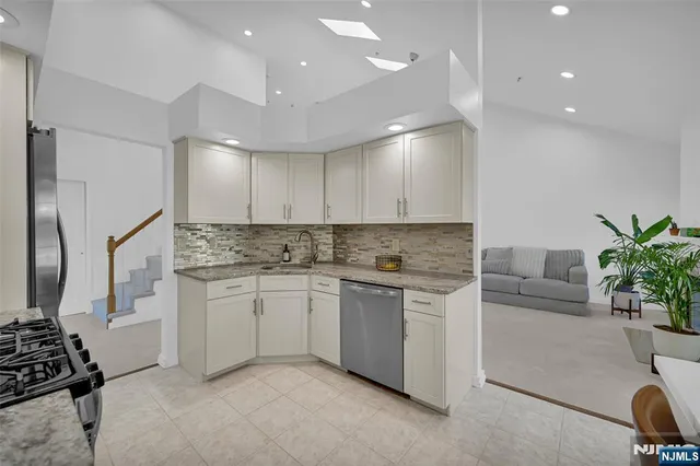 a kitchen that has a sink and a stove in it