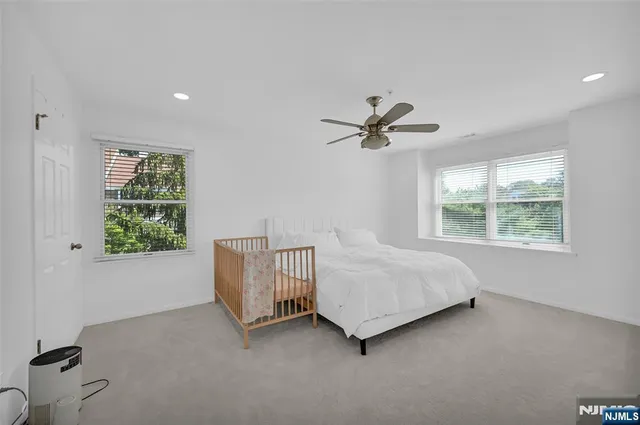 a living room with a bed furniture and a window