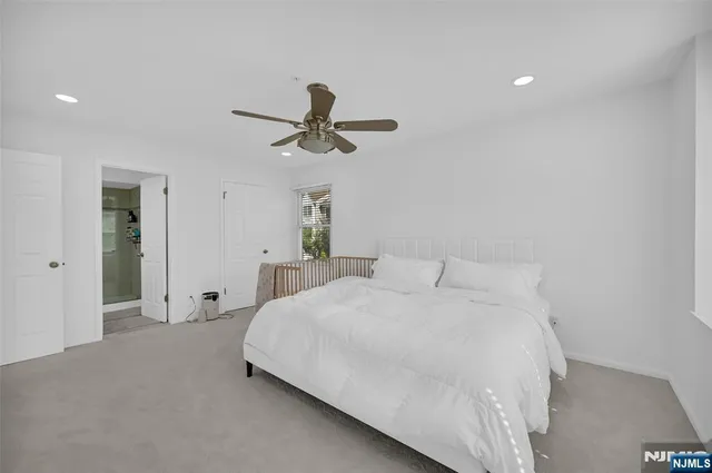 a bedroom with a large bed and a chandelier