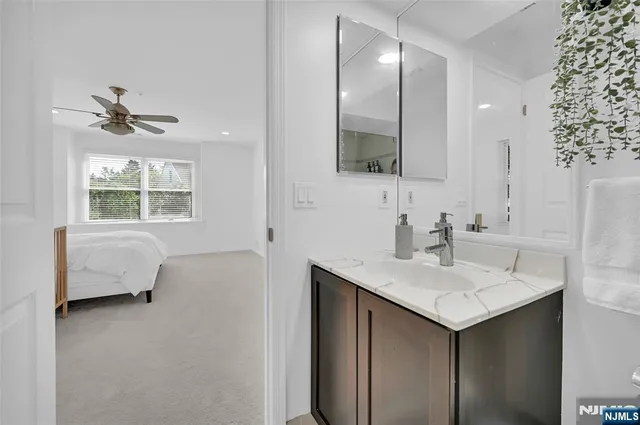a en suite bathroom with a sink double vanity and a mirror