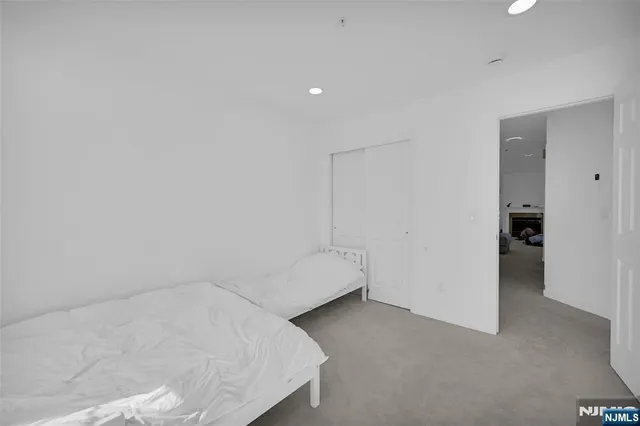 a room with a bed and a wall painting