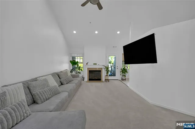 a living room with furniture a fireplace and a flat screen tv