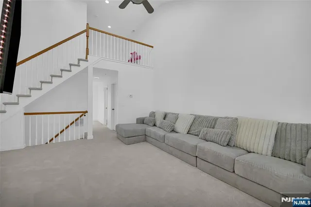 a living room with furniture and stairs