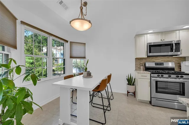 a kitchen with a table and chairs in it