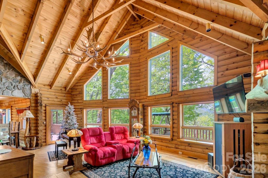 35 Falcon Crest Loop Maggie Valley, NC 28751 - Photo 6 of 46 a living room with furniture a fireplace and a floor to ceiling window